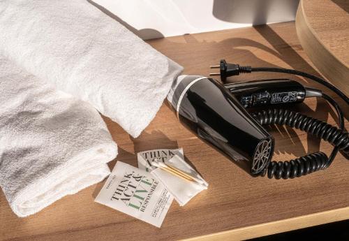 a telephone sitting on a table with a receipt at B&B HOTEL Marne-la-Vallée Val d'Europe in Serris