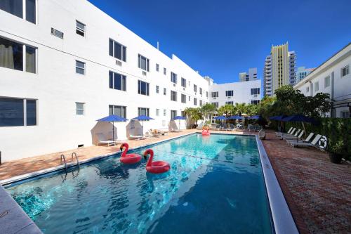 a swimming pool with two pink flamingos in a building at Tropics Hotel Miami Beach in Miami Beach
