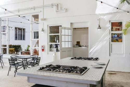 a kitchen with a stove top on a table at Tropics Hotel Miami Beach in Miami Beach