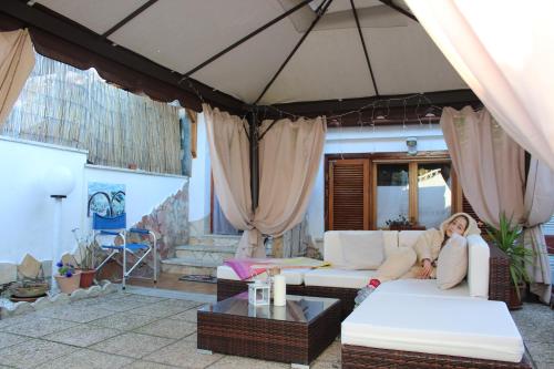 a woman laying on a couch in a living room at Villa Severino Ferrari Anzio in Anzio