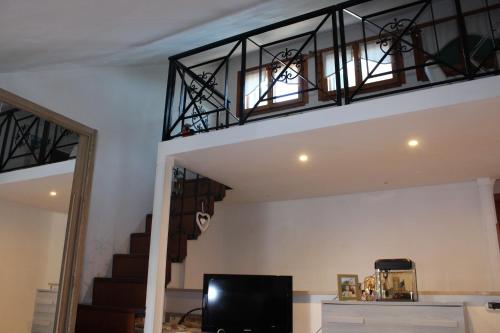 a living room with a staircase and a television at Villa Severino Ferrari Anzio in Anzio