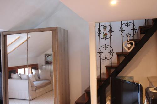 a living room with a staircase and a mirror at Villa Severino Ferrari Anzio in Anzio