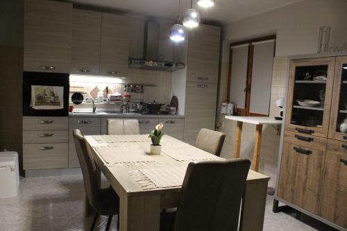 a kitchen with a table and chairs in a kitchen at Villa Severino Ferrari Anzio in Anzio