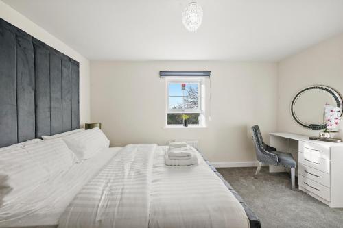- une chambre avec un grand lit blanc et un bureau dans l'établissement Stunning 4 bed In Leicester with Garden & Parking!, à Leicester