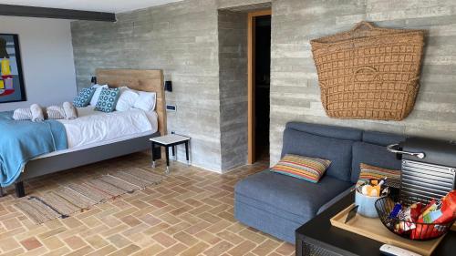 a living room with a bed and a couch at El jardin Botánico Villa LUZ in Altea