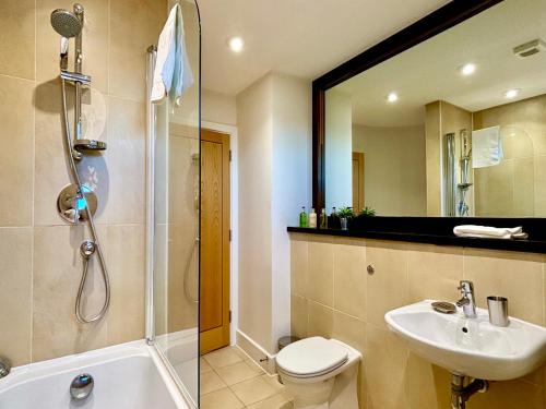 a bathroom with a sink and a toilet and a shower at Your Space Apartments – Hamiltons in Cambridge