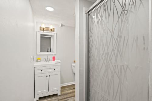 een badkamer met een toilet, een wastafel en een spiegel bij Quaint Guest House With Walkable Locale in Watkins Glen