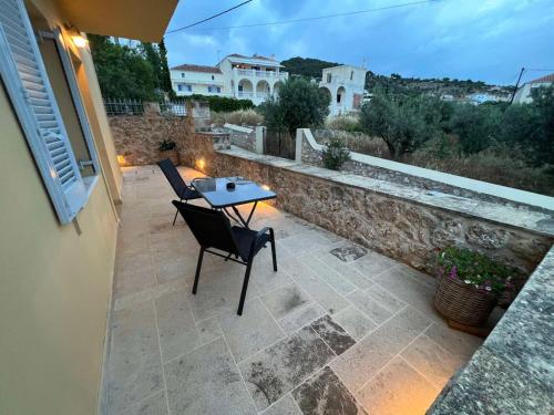 a patio with two chairs and a table on a patio at Vivi's Apartments in Spetses