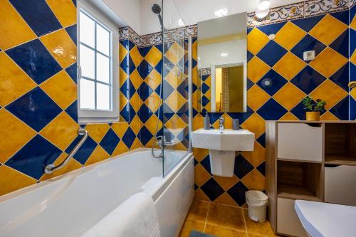 アルヴォルにあるVila Hortenseの黄色と青のタイル張りの壁のバスルーム
