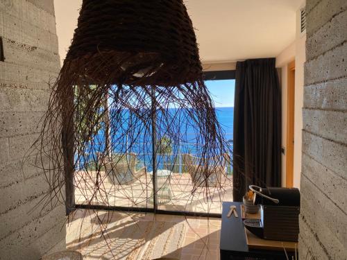 a room with a window with a view of the beach at El jardin Botánico Villa LUZ in Altea