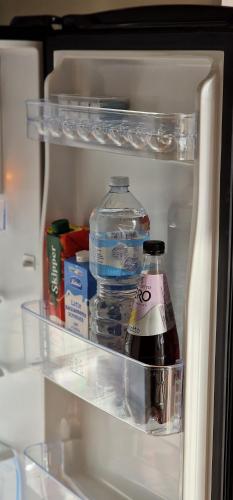 an open refrigerator with a bottle of water and milk at Attico Mexico in Pescara