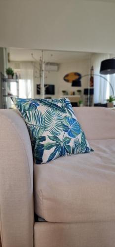 a blue and white pillow sitting on a couch at Attico Mexico in Pescara