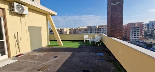 a balcony with tables and chairs on a building at Attico Mexico in Pescara
