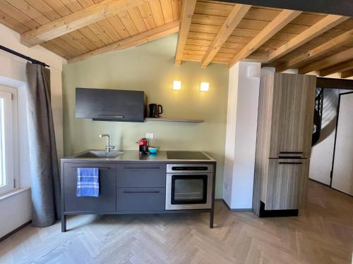 a kitchen with a sink and a stove at Appartamenti Saragozza a due passi da Piazza Grande - WIFI e parcheggio gratuito in Modena