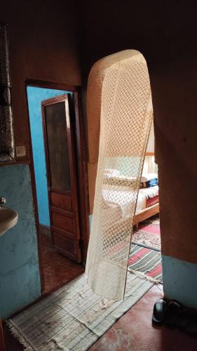 a room with a ladder in a room with a door at maison isabel in Boumalne