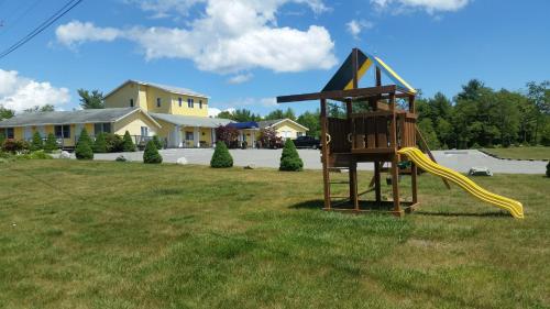 a playground with a slide in a yard at High Seas Motel in Bar Harbor
