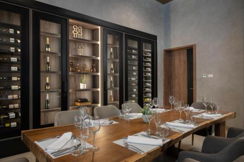 a dining room with a table with wine glasses at Serenade All Suites - Adults Only Resort in Punta Cana