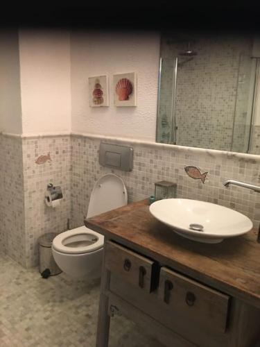 a bathroom with a sink and a toilet in it at Castle81homes Pink - Sea view house in Marmaris