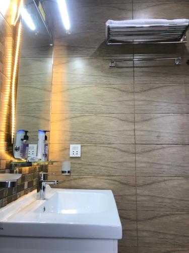 a bathroom with a sink and a mirror at Mukhtar Homes Bahria Town Lahore in Lahore