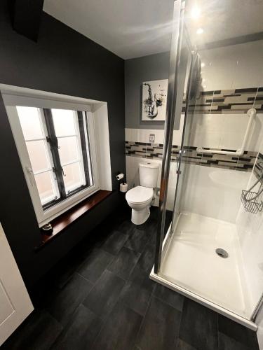 a bathroom with a shower and a toilet at Old Manor House in Axbridge