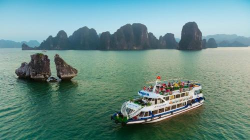 a cruise ship in the water near some rocks at Hanoi EcoStay 1 hostel in Hanoi