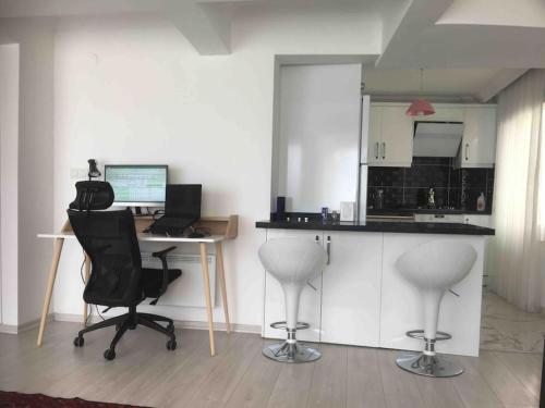 a kitchen with a desk with a computer and two chairs at Castle81homes Red, sea view central flat in Marmaris
