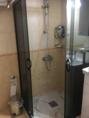 a shower with a glass door in a bathroom at Castle81homes Red, sea view central flat in Marmaris