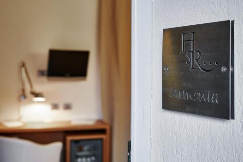 a hotel room with a sign on a wall at San Rocco Hotel in Scanzorosciate