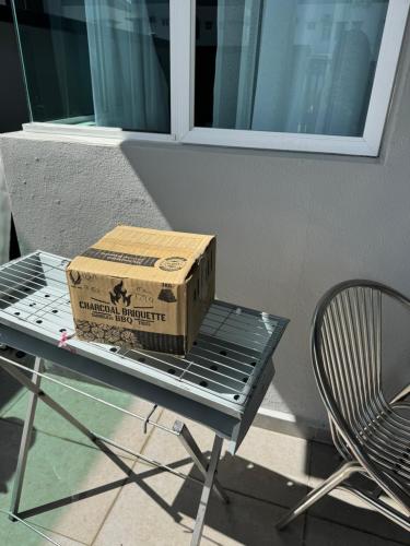 a box sitting on top of a metal table at Sekinchan 2008 Homestay Karaoke BBQ in Sekincan