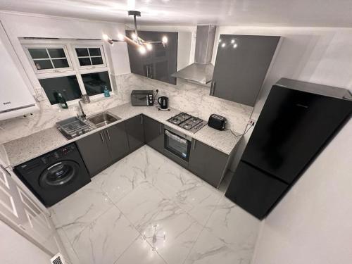 an overhead view of a kitchen with a sink and a stove at Spacious & Lovely 4 Bedroom Home in Manchester in Manchester