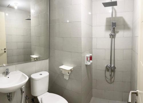 a bathroom with a toilet and a sink and a shower at 2 BR I ANDERSON I 25floor I above pakuwon mall I the biggest shopping center in Surabaya
