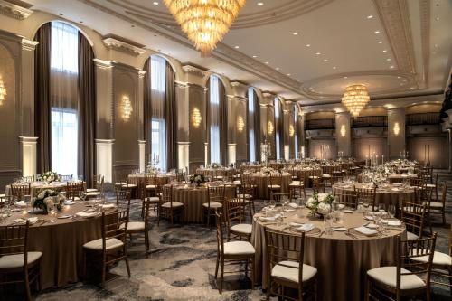 a ballroom with tables and chairs in a room with windows at The Westin Book Cadillac Detroit in Detroit