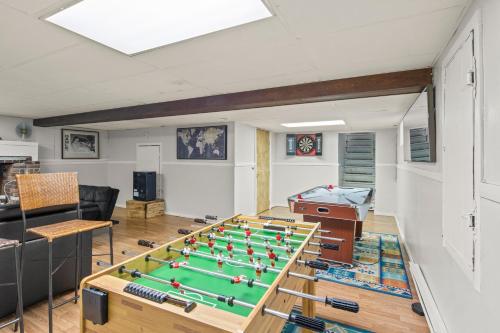 a living room with a table with pool tables at Walk To Parks, Dining & Lake! Game Room! Hot Tub! in Watkins Glen