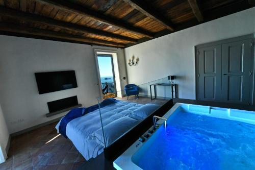 a bedroom with a bed and a swimming pool at In Costa Relais & Luxury Suites in Vietri sul Mare
