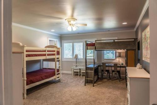 a bedroom with two bunk beds and a dining room at Sleeps 14 - Pinehurst in Pinehurst
