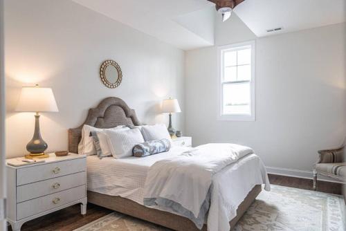 a white bedroom with a bed and a window at Sleeps 6-Southern Pines in Southern Pines