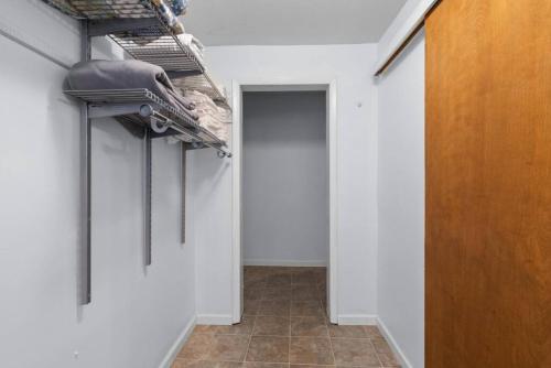 a hallway with a row of hangers on a wall at Slice of Seclusion in Downtown Southern Pines in Southern Pines