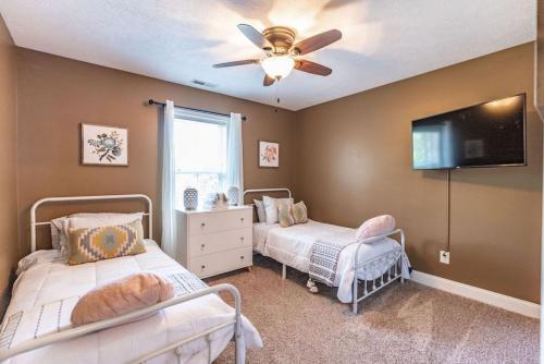a bedroom with two beds and a ceiling fan at Perfect Pinehurst Getaway- Walkable to the Village in Pinehurst