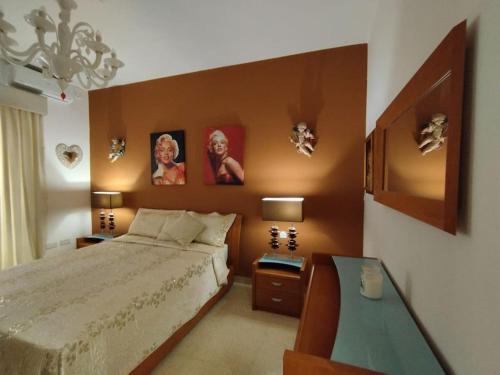 a bedroom with a large bed and a table at Tal-Munfuha- Centrally Located Space. in Valletta