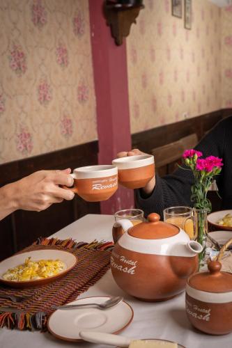 a person sitting at a table with bowls and plates of food at Casona Del Rosario - Plaza de Armas in Chachapoyas