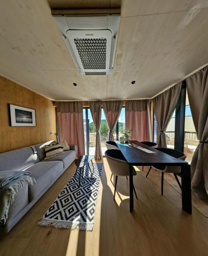 a living room with a table and a couch at Jazine beach villas in Tisno