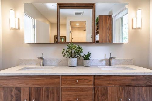 a bathroom with two sinks and a mirror at Sleeps 6-Whispering Pines Lake Front 