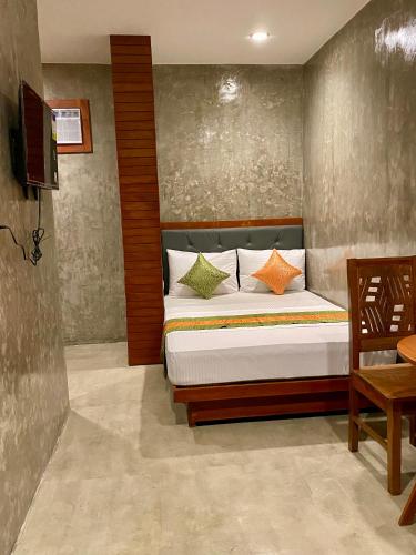 a bedroom with a bed and a television in it at RL Harbor Inn in El Nido