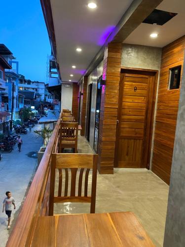 a row of tables and benches in a restaurant at RL Harbor Inn in El Nido