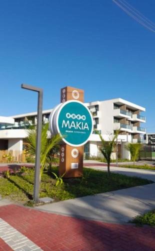 a sign in front of a building at Flat Makia Beach Experience Muro Alto in Porto De Galinhas