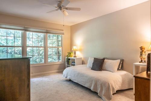 a bedroom with a bed and a ceiling fan at Sleeps 7- Whispering Pines Lake Front 