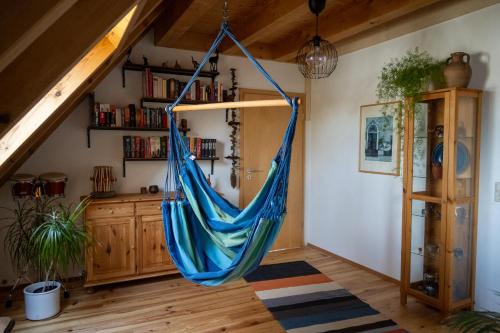 a hammock hanging from the ceiling in a room at FeWo Dattingen am Dorfrand mit Parkplatz, Wlan und Kamin 