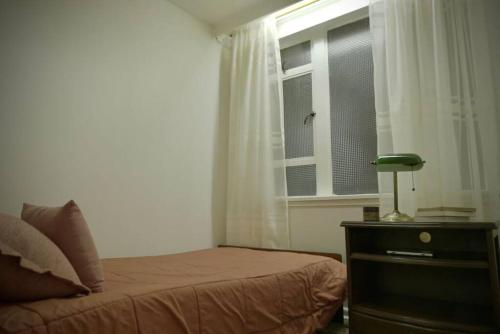a bedroom with a bed and a window at Apartamento completo centro de Bogotá in Bogotá