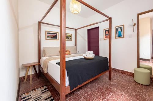 a bedroom with a four poster bed with a mirror at Hotel Casa do Bispo in Manaus