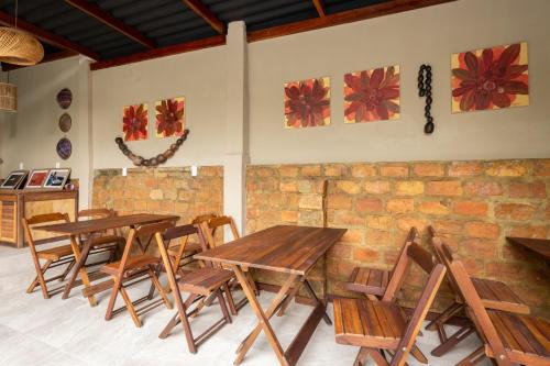 a dining room with wooden tables and chairs at Hotel Casa do Bispo in Manaus
